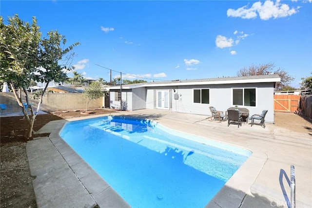 view of swimming pool with a patio and a trampoline