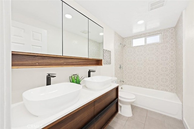 full bathroom with vanity, toilet, tile patterned floors, and tiled shower / bath