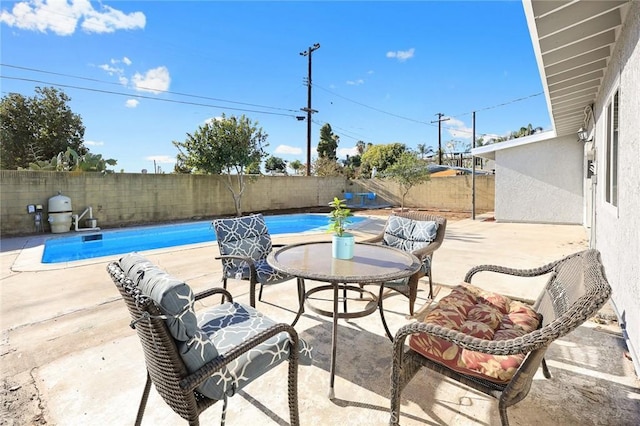 view of patio / terrace with a fenced in pool