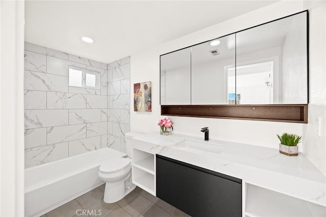 full bathroom with toilet, vanity, tiled shower / bath, and tile patterned flooring