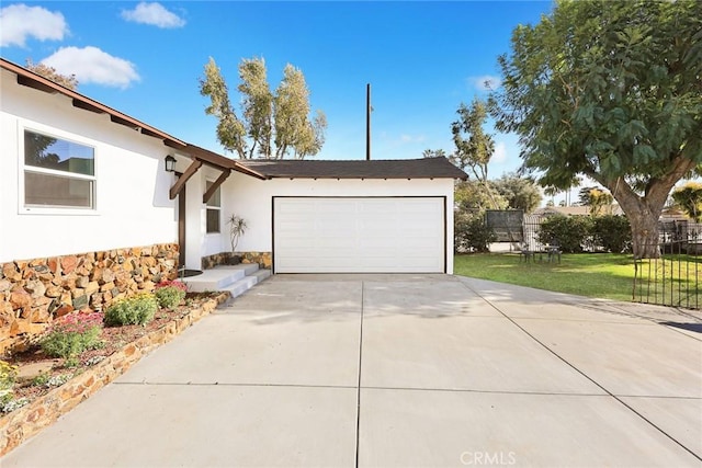 exterior space featuring a garage and a front lawn