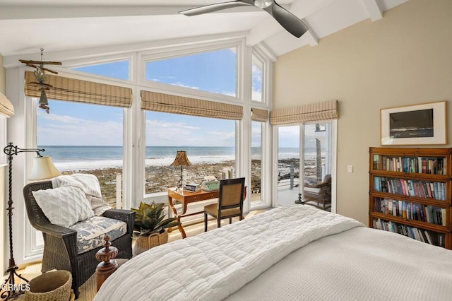 bedroom with access to outside, lofted ceiling with beams, a water view, ceiling fan, and a view of the beach