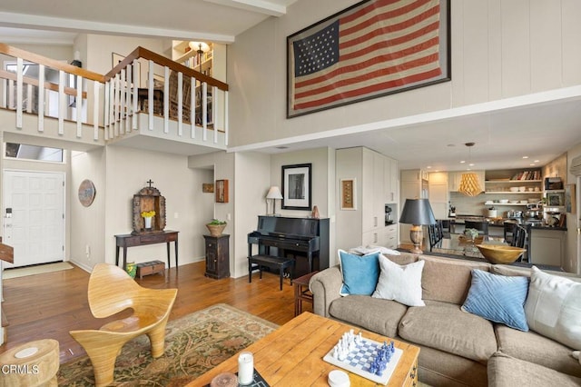 living room with hardwood / wood-style flooring and a high ceiling