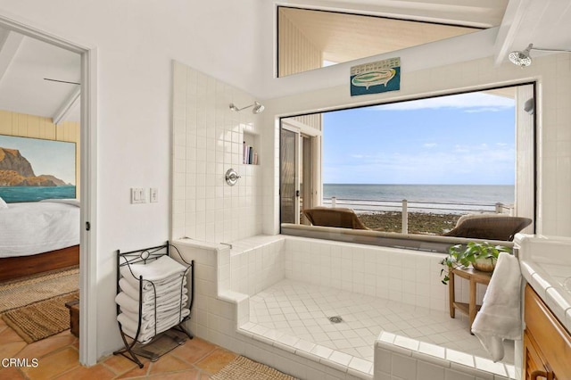 bathroom featuring plenty of natural light, tiled shower, and a water view