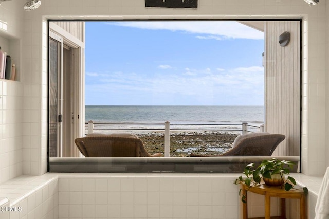 balcony with a water view and a beach view