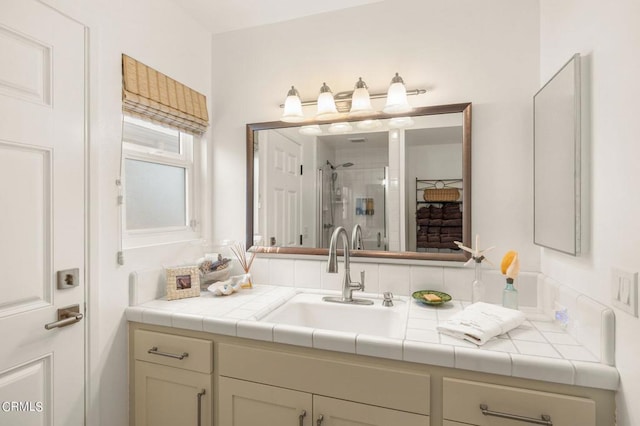 bathroom with a shower with door and vanity