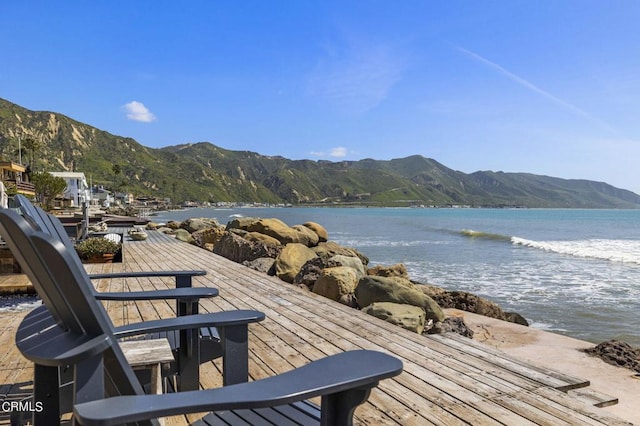 view of dock with a water and mountain view