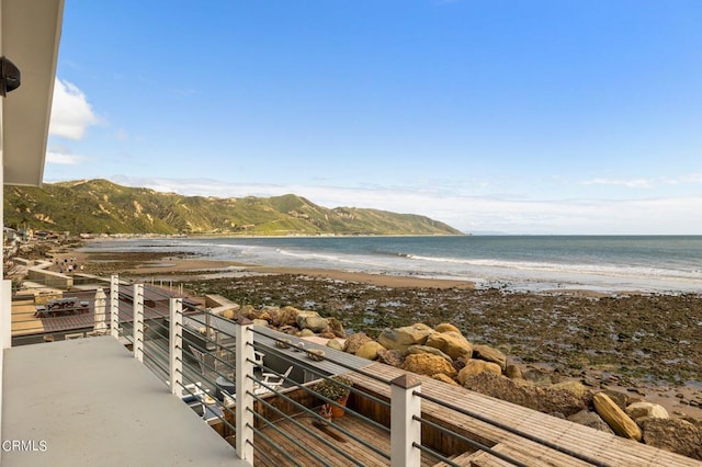 property view of water featuring a mountain view and a view of the beach