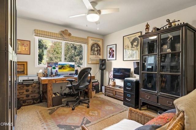 home office featuring light carpet and ceiling fan