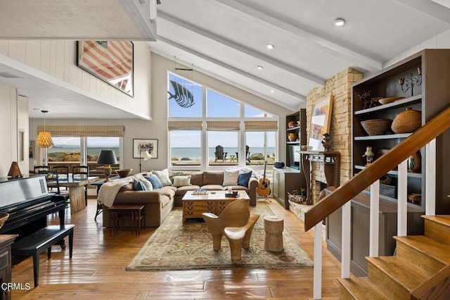 living room featuring hardwood / wood-style floors and lofted ceiling with beams