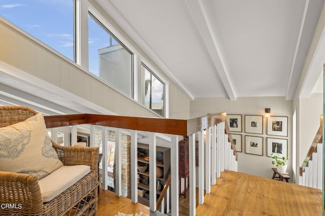 stairs featuring hardwood / wood-style flooring and beam ceiling