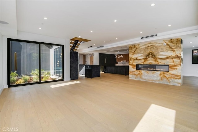 unfurnished living room featuring hardwood / wood-style flooring and a fireplace