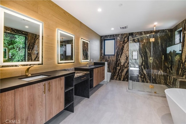 full bathroom with toilet, tile walls, vanity, wood walls, and separate shower and tub