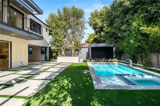 view of swimming pool featuring an in ground hot tub, a patio area, and a lawn