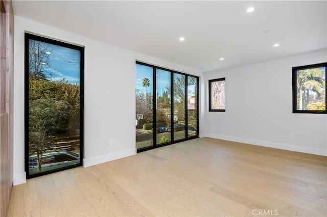 empty room with light hardwood / wood-style flooring