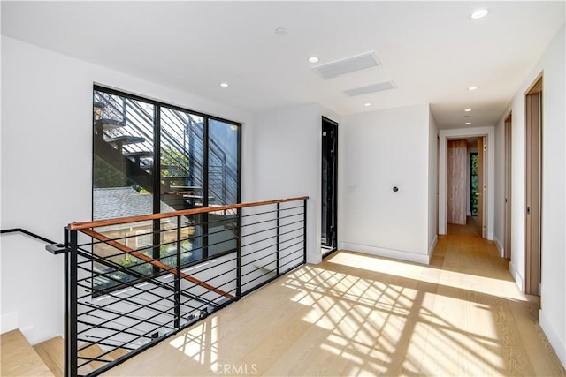 corridor with light hardwood / wood-style floors