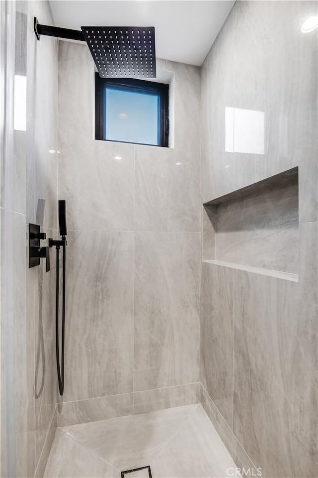 bathroom with tiled shower