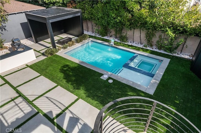 view of pool with an in ground hot tub, a yard, and a patio