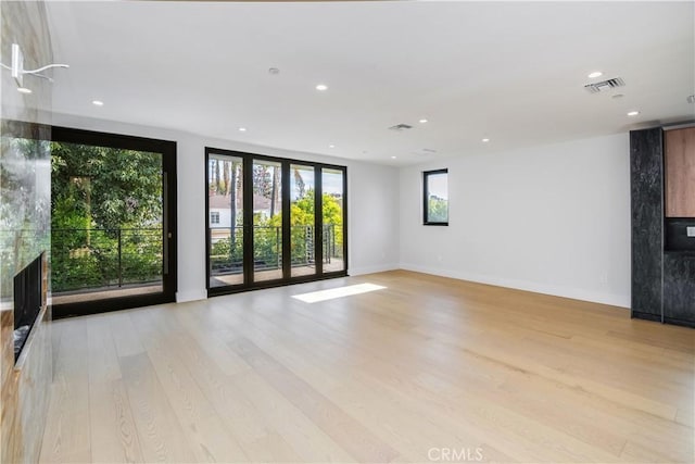 unfurnished living room with light wood-type flooring