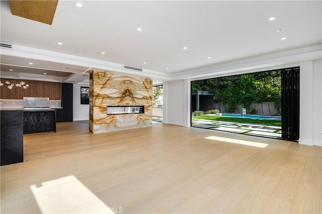 unfurnished living room with light wood-type flooring and a fireplace