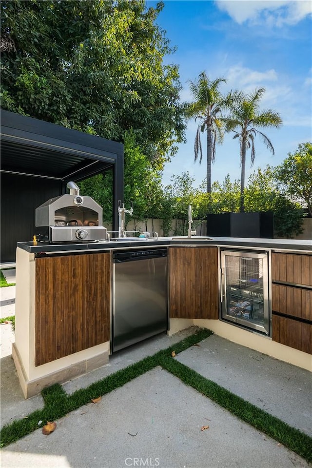 view of patio / terrace with area for grilling and wine cooler