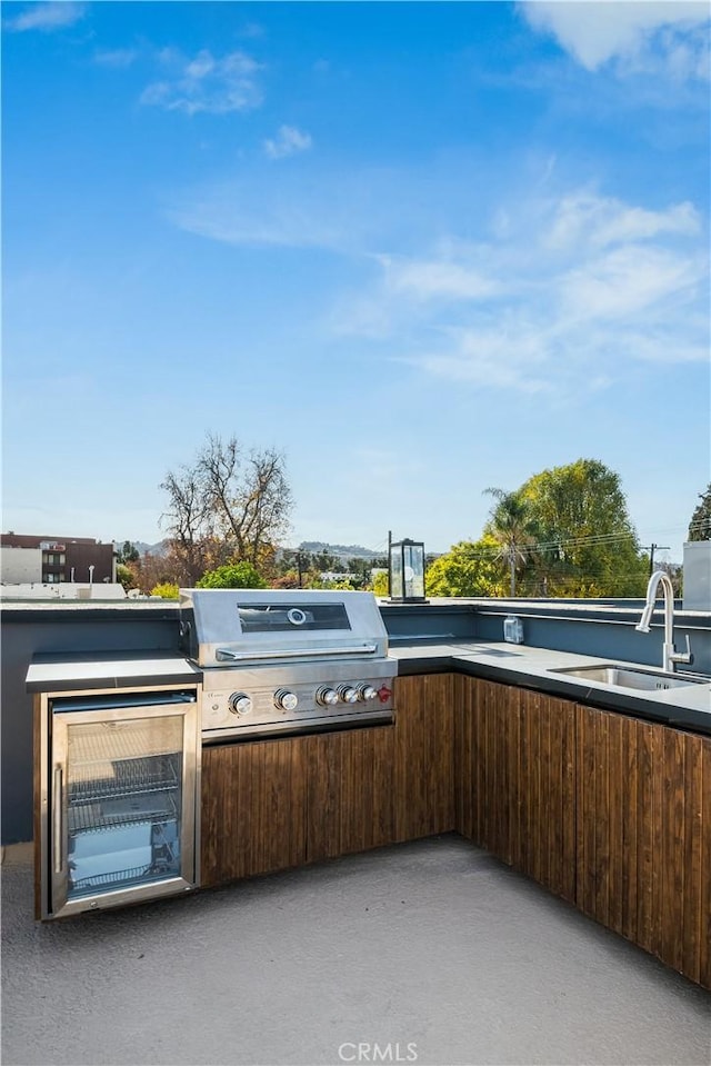 view of patio / terrace featuring area for grilling and sink