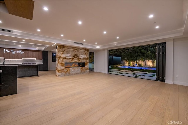 living room with light hardwood / wood-style floors and a fireplace