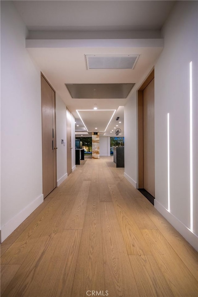 corridor featuring light hardwood / wood-style flooring