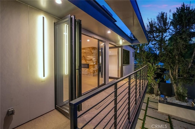 view of balcony at dusk