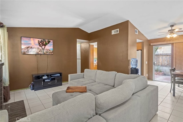 living room with lofted ceiling, light tile patterned floors, and ceiling fan