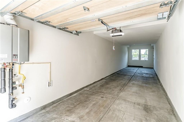 garage featuring a garage door opener and baseboards