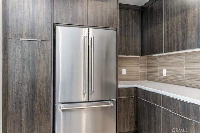 kitchen featuring dark brown cabinets, high quality fridge, light countertops, and modern cabinets