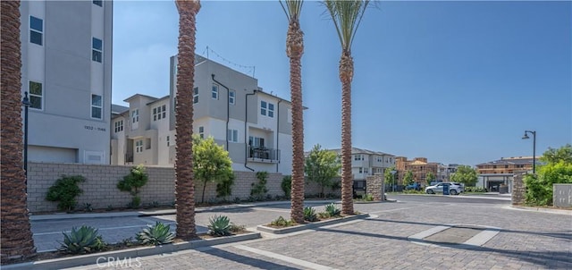 view of street with a residential view, curbs, street lighting, and sidewalks