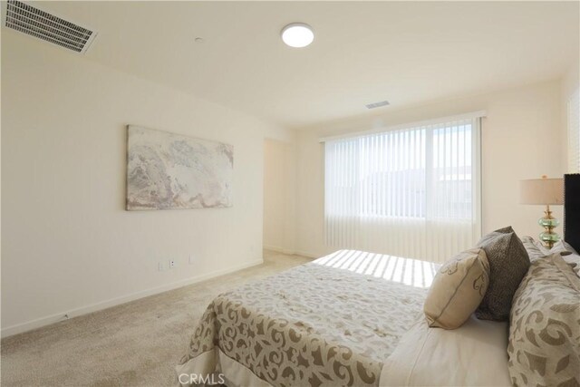 bedroom featuring light carpet