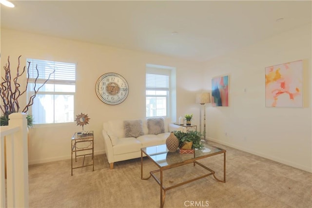 living room with a healthy amount of sunlight and light colored carpet