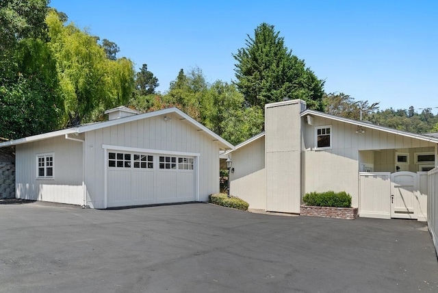 view of front of property featuring a garage and an outdoor structure