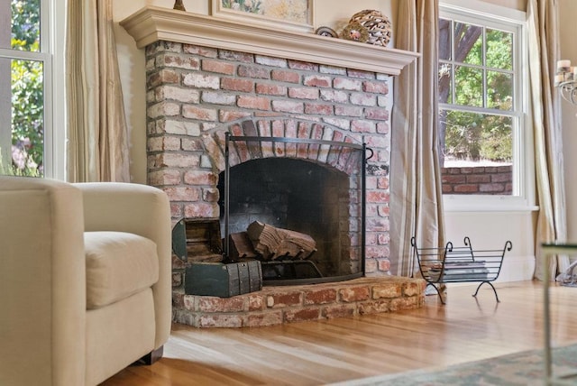 details featuring a brick fireplace and hardwood / wood-style flooring