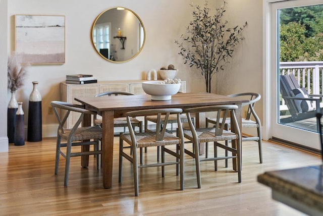 dining space with hardwood / wood-style flooring