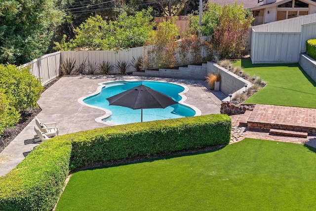 view of swimming pool featuring a lawn and a patio