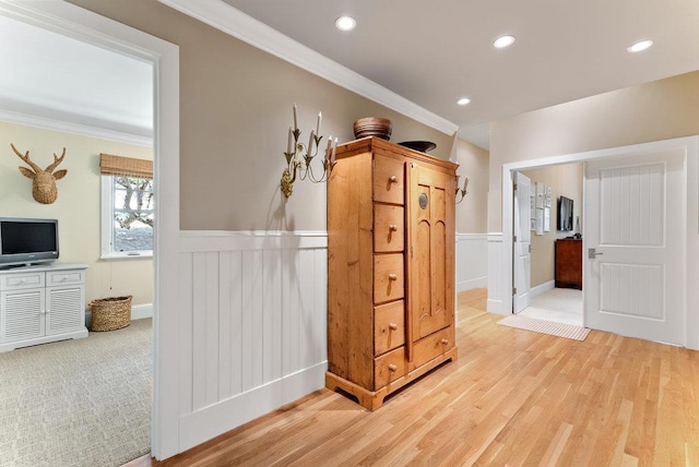 corridor with crown molding and light wood-type flooring