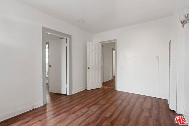 spare room with dark wood-type flooring