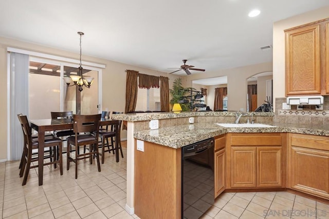 kitchen with kitchen peninsula, pendant lighting, dishwasher, sink, and decorative backsplash