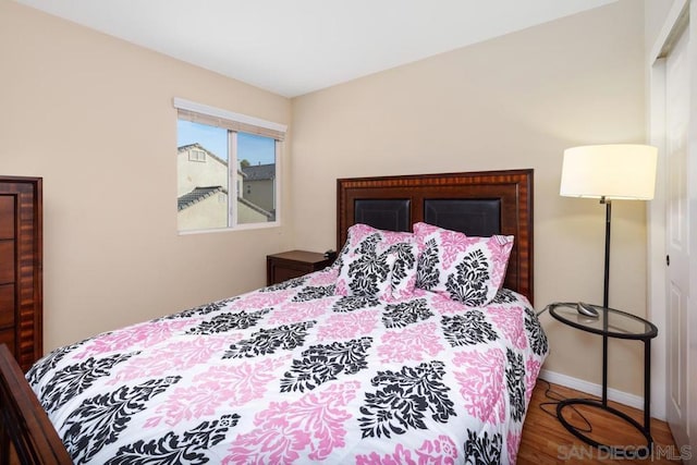 bedroom with wood-type flooring