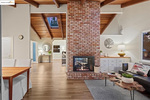 living room featuring wooden ceiling, light hardwood / wood-style flooring, and a fireplace