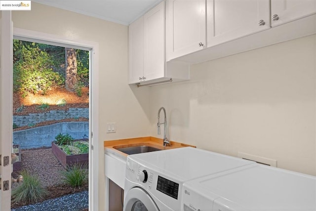 laundry room featuring sink, cabinets, and separate washer and dryer