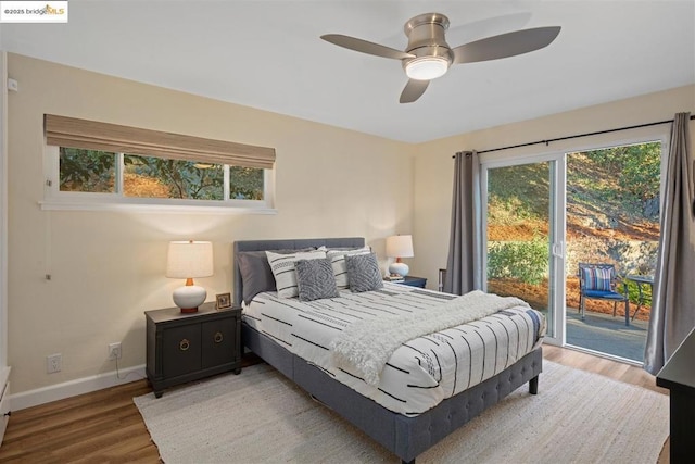 bedroom with wood-type flooring, ceiling fan, and access to outside