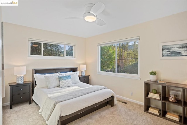 bedroom with light carpet and ceiling fan