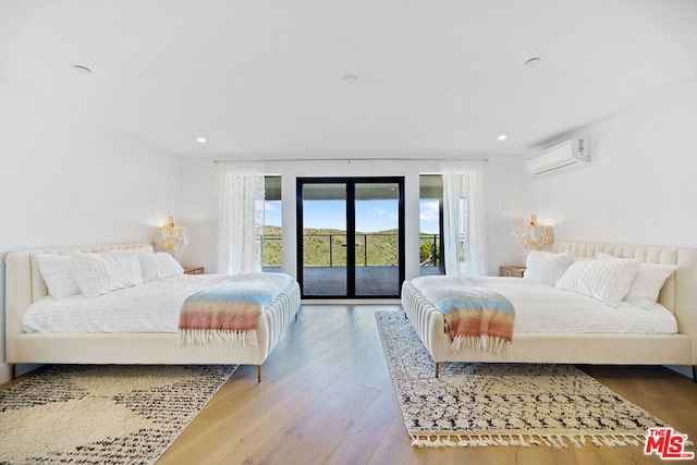 bedroom featuring light hardwood / wood-style flooring, access to outside, french doors, and a wall mounted AC