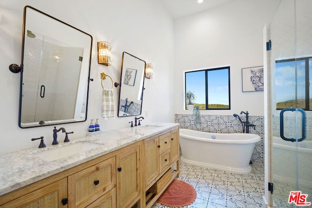 bathroom featuring vanity, tile patterned flooring, and shower with separate bathtub