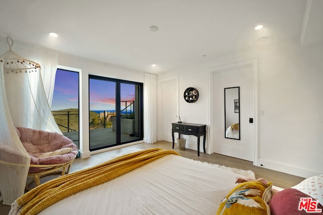 bedroom featuring hardwood / wood-style flooring and access to outside